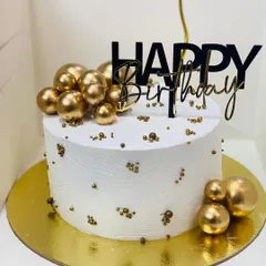 A simple yet elegant white and gold birthday cake, perfect for a minimalist celebration.