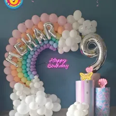 For Mehar's 9th birthday, I created this beautiful pastel rainbow balloon arch. The setup included her name in silver foil letters, a "Happy Birthday" neon sign, and themed pedestals for the cake.