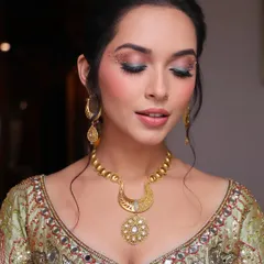 It's all in the eyes. For this Mehendi look, I used a beautiful blend of pink and green eyeshadow, accented with delicate studs and gold dust for a touch of magic.