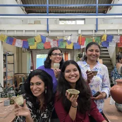 Happy students showing off their finished, glazed pieces after a kiln opening. It's a moment of pride and accomplishment, seeing their hard work come to fruition.