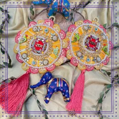 These stunning Indo-Western "Ram Ram" signs are part of a cherished ritual that strengthens the sibling bond. This yellow and pink design with parrot motifs and tassels is a beautiful blend of heritage and modern style.