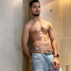 A casual, shirtless look in jeans. This demonstrates a natural, healthy physique that's relatable and aspirational for lifestyle and fashion brands.
