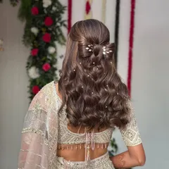 A wider shot of the half-up bow hairstyle, showing how it looks with the full outfit. The style adds a touch of whimsy and romance to this stunning engagement look.