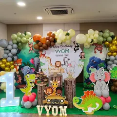 A cute and friendly jungle animal theme with a circular backdrop and a full balloon garland. This setup includes multiple character cutouts and a large light-up number '1'.