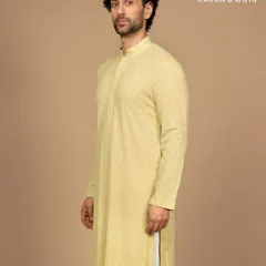 A modern classic in quiet hues. This pastel woven kurta is tailored in a fine-textured fabric with a subtle diamond pattern. The clean mandarin collar and concealed placket make it perfect for daylight rituals and moments that matter.