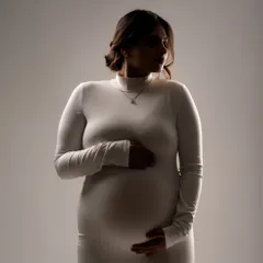 A close-up silhouette in a simple white dress. This technique uses light and shadow to create a soft, intimate, and artistic portrait.