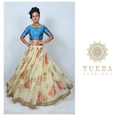A fresh and modern lehenga set perfect for a sangeet or mehendi. I paired a rich blue brocade blouse with a light, airy skirt featuring a vibrant floral print and a delicate mirror-work border.