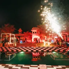 A cocktail night designed as a playground for the senses. This wide shot shows how we used neon-lit structures, a checkered poolside, and dramatic pyrotechnics to create a luxurious and wild atmosphere at The Oberoi Udaivilas.