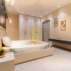 This view showcases the custom floor-to-ceiling wardrobe with sleek handles and a floating study or dressing table. The combination of white and grey creates a calm and modern aesthetic.