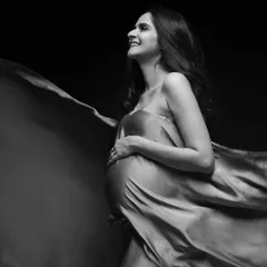 There is so much joy in simplicity. A single piece of fabric and the right light can create a timeless, high-contrast black and white portrait that feels both powerful and happy.