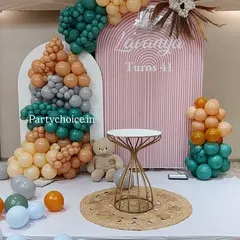 A chic and modern boho theme for a 41st birthday. This setup features arched backdrops, a stylish balloon arrangement in earthy tones, and pampas grass accents for a sophisticated look.