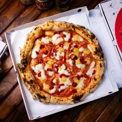 A classic mozzarella pizza, boxed up and ready for delivery from our Amar Colony outlet.