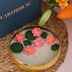 This is my signature Lotus Pond Urli candle. The hand-sculpted pink lotus flowers and green lily pads float in serene white wax, creating a miniature tranquil pond.