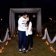 A romantic night-time pre-wedding setup with candles and drapes. We can arrange and capture unique, intimate settings for couples looking for a creative photoshoot experience.