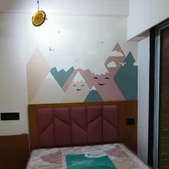 A modern and cute mountain range wallpaper for a kid's room. The smiling mountains and soft pastel colors create a sweet and calming atmosphere above the bed.