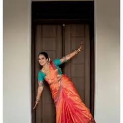 A playful and candid moment from a baby shower shoot. The expecting mother's joyful pose shows that even in traditional attire, we can capture your unique personality and happiness.