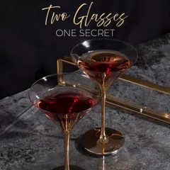 An intimate moment with one of our creations. The elegant glassware and rich color of the cocktail hint at the secret to our service: quality ingredients and masterful crafting.