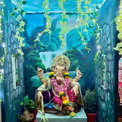 Even a small corner in a home can be transformed into a sacred space. Here, I painted a serene waterfall backdrop on manjarpat cloth and created a 360-degree jungle theme with painted walls and ceiling to welcome Ganpati.