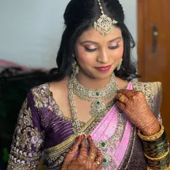 A close-up of Pavitra's reception makeup. This look features shimmery pink and silver eyeshadow, flawless skin, and diamond jewelry, creating a sophisticated and glamorous effect.