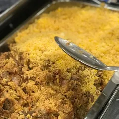 On high demand, our delicious Mutton Biryani is a crowd favorite. This close-up shot shows the perfectly cooked, flavorful rice and tender mutton, ready to be served to eager guests.