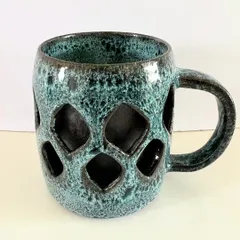 Part of my double-walled mug series, this piece features a geometric diamond pattern. The technique makes the mug surprisingly lightweight and comfortable to hold.
