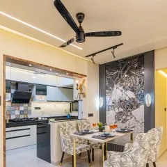 Here you can see the seamless transition from the dining area to the semi-open kitchen. This layout is great for entertaining, allowing for easy conversation and connection between the two spaces.