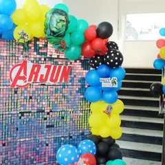 For this Avengers party, I created a shimmering sequin backdrop with the birthday boy's name, Arjun, right in the middle. The Hulk and other hero balloons add to the powerful, fun-filled vibe.