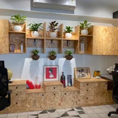Your home office should be a place of inspiration. I designed this creative workspace using a combination of potted plants on modular shelving and hanging planters to add layers of green, making the room feel more dynamic and peaceful.