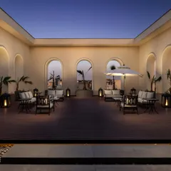 We designed this serene rooftop terrace as an open-air lounge. The space uses classical arches to frame city views, with comfortable seating arrangements and soft lantern lighting creating a tranquil, luxurious escape under the evening sky.