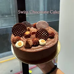 A classic Swiss Chocolate Cake, decorated with intricate chocolate work. Nothing beats the classics, especially when they are taught with such grace.