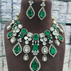 A magnificent necklace set featuring large emerald-cut green stones surrounded by sparkling American Diamonds. This is a high-impact piece for any grand occasion.