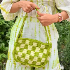 A close-up of the handcrafted details of our checkered crochet bag, showing the texture and quality of the yarn work.