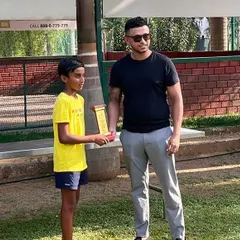 A young U12 winner is presented with his trophy at the KSLTA State Ranking Tennis Tournament. Our events provide a platform for junior players to earn state and national ranking points.