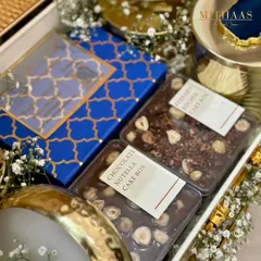 A peek inside a gender reveal hamper, showcasing my Chocolate Nutella and Ferrero Rocher cake boxes. The royal blue packaging adds to the suspense and excitement of the special moment.