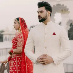 A portrait of the groom. Standing proud in his bespoke ivory sherwani, our client embodies the quiet confidence and regal charm that we strive to deliver with every garment.