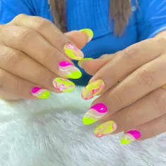 Vacation nails done right. This vibrant set features a neon yellow and pink marble design, perfect for making a statement on your next trip.