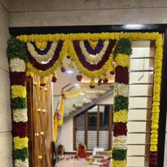 We decorated the main entrance of this home for a Gruhapravesam with thick, colorful garlands of fresh flowers, creating a warm and auspicious welcome for family and guests.