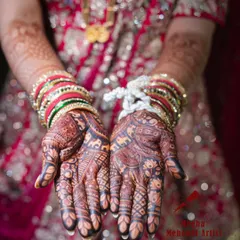 The deep, rich color of the bridal mehendi is stunning against the bride's red attire and bangles. This photo shows the beautiful stain my henna can achieve.