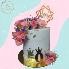 A 50th birthday deserves nothing less than elegance. I designed this tall cake with a cascade of fresh pink and purple roses, accented with delicate baby's breath and edible gold leaf, creating a sophisticated centerpiece for a landmark celebration.