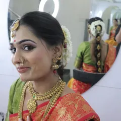 This beautiful South Indian bridal look was created by one of my talented students under my guidance. The mirror shot perfectly captures the complete look, including the detailed hairstyle.