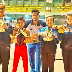 A showcase of success at the Dasara CM Cup Championship. Our gymnasts proudly display their impressive collection of medals with their coach.
