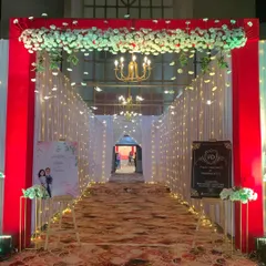 This classic entrance gate uses a bold red frame, a canopy of white flowers, and sparkling fairy lights to create a warm and welcoming passage for guests. I also provide custom welcome signs for a personal touch.