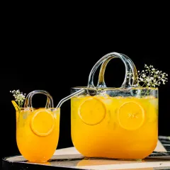 We believe a cocktail should be a piece of art. This custom drink, served in a unique handbag-shaped glass pitcher and cup, shows our commitment to creative presentation and detail.
