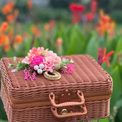 The same versatile rattan suitcase, shown here with a beautiful floral arrangement on top. This is how we begin to customize a hamper to match your theme and style.