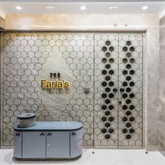 The entrance with the security door closed, showcasing the full fish-scale pattern that flows from the wall onto the door itself. The gold nameplate and modern console complete the luxurious look.