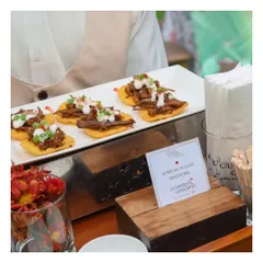 An example of our Asian-fusion appetizers. This tray features Korean Pulled BBQ Pork served on crisp tortilla chips, topped with a creamy sauce and fresh herbs.
