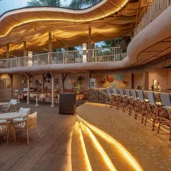 The main bar at Dubki at dusk, with warm lighting highlighting its curved form. The bar is integrated into the lower level, with a bamboo-clad backdrop and woven bar stools that reinforce the project's earthy, sustainable material palette.