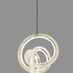 A modern LED pendant with intertwined, crystal-encrusted rings. This compact and stylish light is perfect for a small dining nook or as a cluster in a larger space.