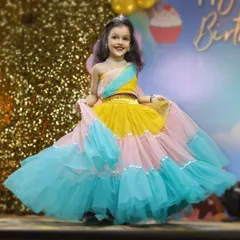 The birthday girl shines in her colorful party dress. Our kids' portrait sessions are all about capturing their personality, and we make sure to get beautiful, happy shots like this one amidst the celebration.