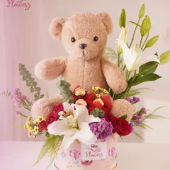 My popular teddy bear gift hamper combines a beautiful arrangement of white lilies and red roses with Ferrero Rocher chocolates and a cuddly teddy bear. It's an all-in-one gift designed to deliver joy and affection.